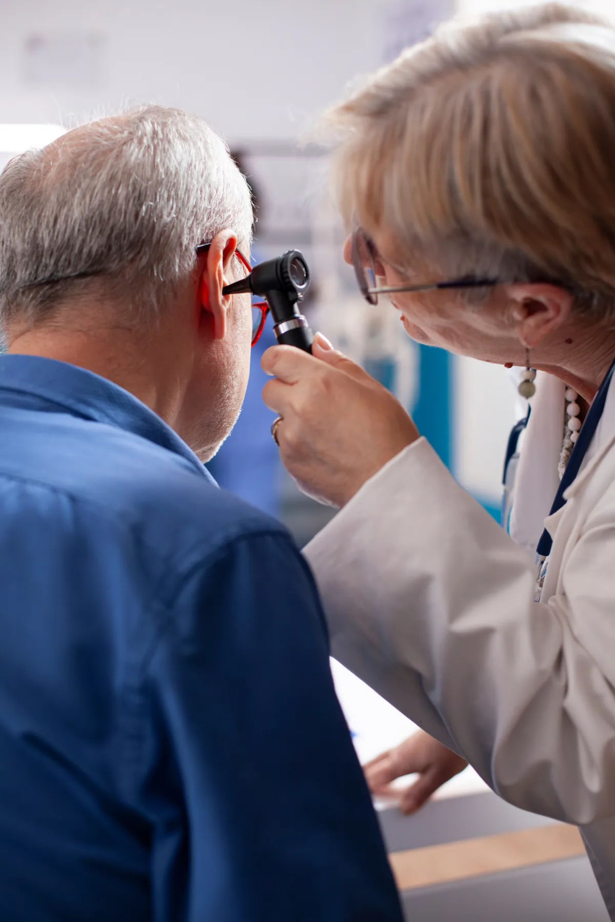 Audiologist examining a patient’s ear