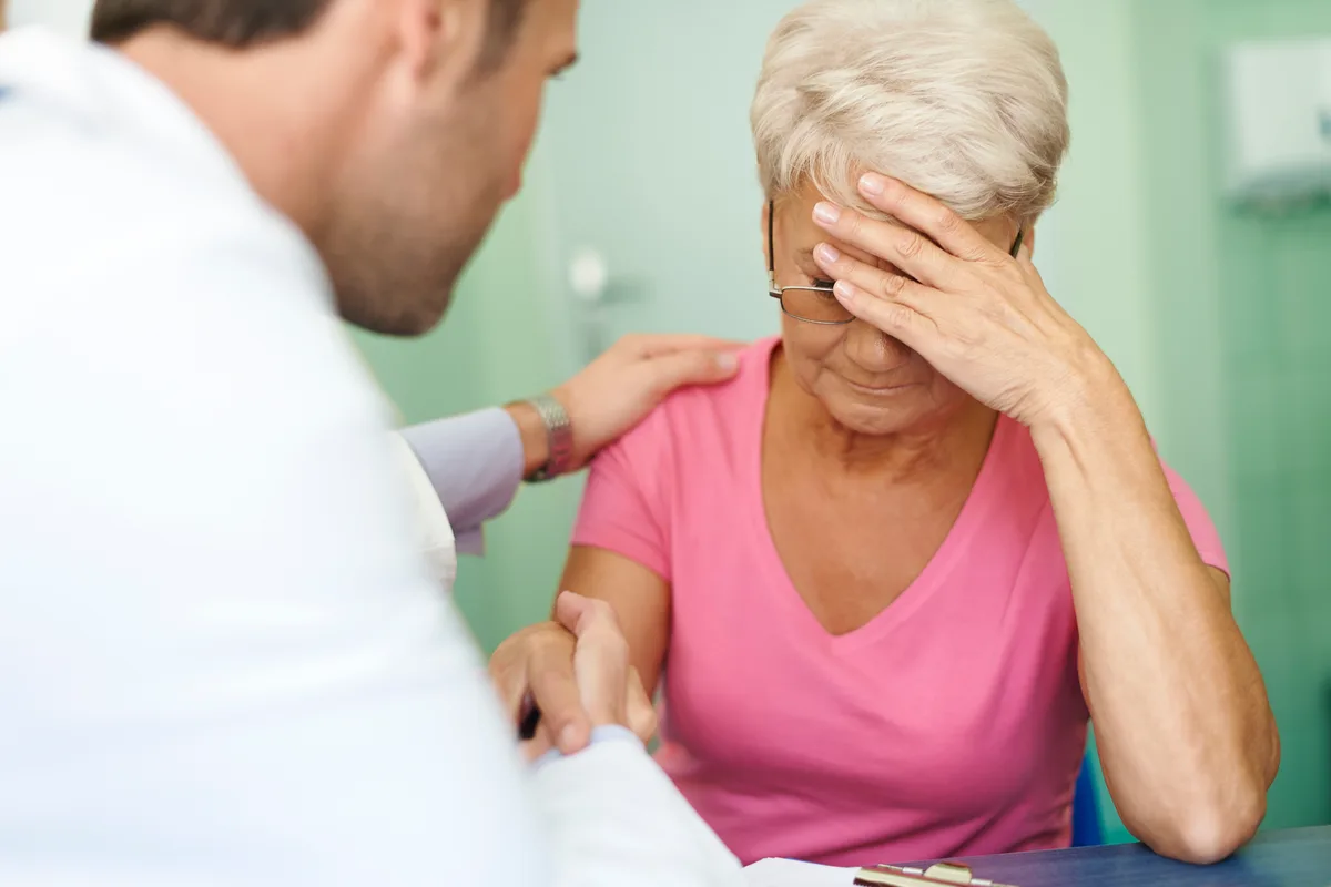 Patient speaking with a healthcare professional about migraine symptoms